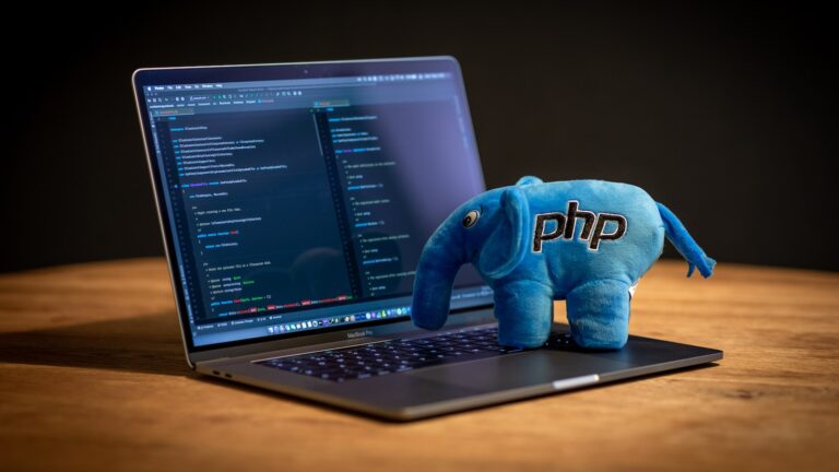 blue elephant plush toy on black laptop computer